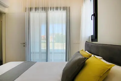 a bedroom with a bed with yellow pillows and a window at Phaedrus Living: Sea View Anna Residence 202 in Limassol