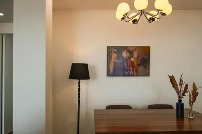 a dining room with a lamp and a painting on the wall at Phaedrus Living: Sea View Anna Residence 301 in Limassol