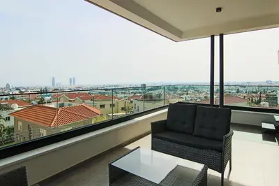 a living room with a chair and a large window at Phaedrus Living: Sea View Anna Residence 302 in Limassol