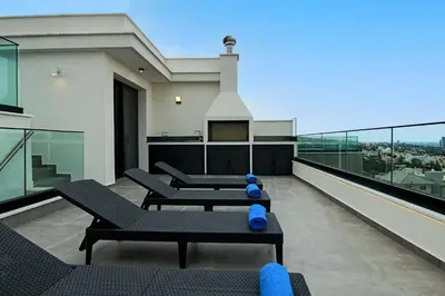 a balcony with couches and blue pillows on a building at Phaedrus Living: Sea View Anna Residence 302 in Limassol
