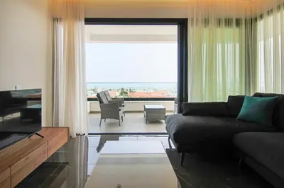 a living room with a couch and a large window at Phaedrus Living: Sea View Anna Residence 302 in Limassol
