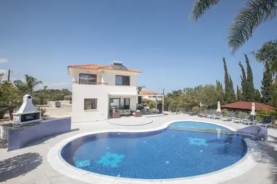 a villa with a swimming pool and a house at Villa Margarita in Protaras