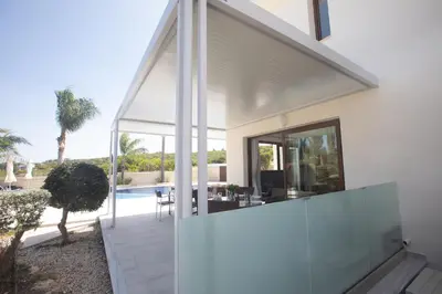 a glass extension to a house with a pool at Villa Margarita in Protaras