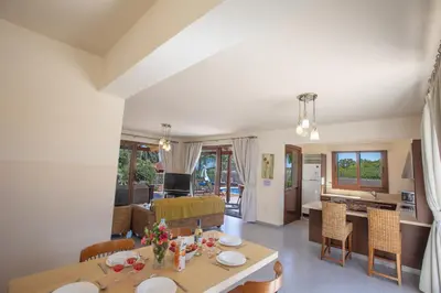 a kitchen and living room with a table and chairs at Villa Margarita in Protaras