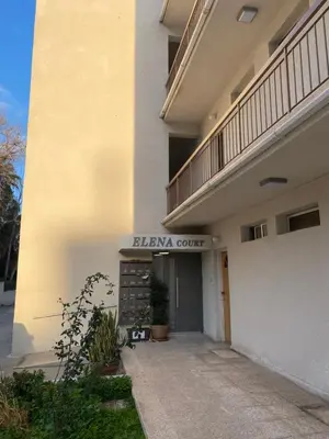 a building with a sign that reads bizzeria court at 1 bedroom flat 200m from the beach in germasogia tourist area in Limassol