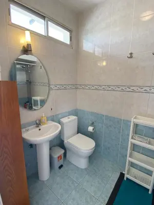 a bathroom with a sink and a toilet and a mirror at 1 bedroom flat 200m from the beach in germasogia tourist area in Limassol