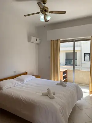 a bedroom with a bed with two towels on it at 1 bedroom flat 200m from the beach in germasogia tourist area in Limassol