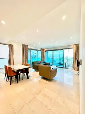 a living room with a couch and a table at Aphrodite Plaza in Larnaka