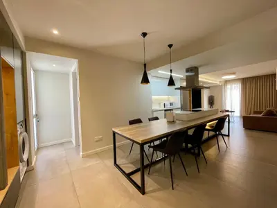 a kitchen and dining room with a table and chairs at Central Business Suites Nicosia - Araouzou By Platform 357 in Nicosia