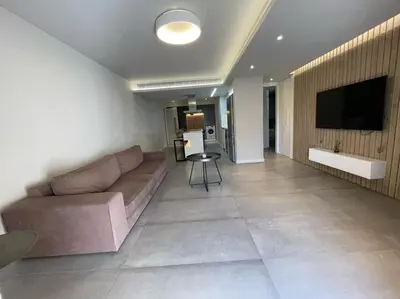 a living room with a couch and a flat screen tv at Central Business Suites Nicosia - Araouzou By Platform 357 in Nicosia