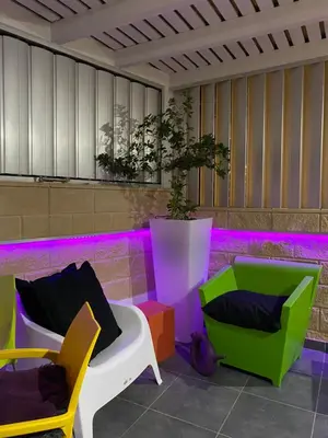 a room with two chairs and a table with purple lights at Purple Villa Protaras - Paralimni in Paralimni