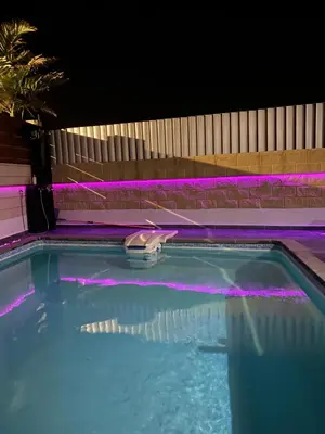 a swimming pool at night with purple lights at Purple Villa Protaras - Paralimni in Paralimni