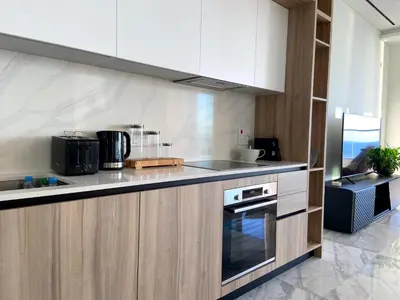a kitchen with white cabinets and a stove top oven at ICON - Private Holiday Apartments in Limassol