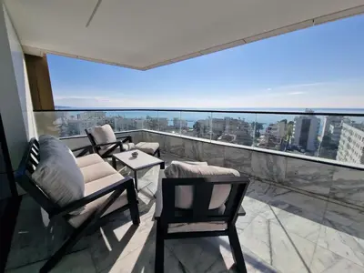 a balcony with chairs and a view of the city at ICON - Private Holiday Apartments in Limassol