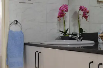 a bathroom with a sink and a blue towel at MAMA'S FLAT - ΤΟ ΔΙΑΜΕΡΙΣΜΑ ΤΗΣ ΜΑΜΑΣ in Strovolos