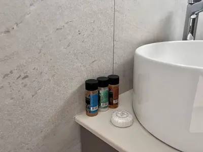 a bathroom with three bottles of essential oils on a counter at Luxury 2-floor Villa with Private Swimming Pool in Paralimni