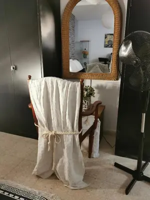 a room with a mirror and a chair with a towel at Lovely Cozy Apartment in the entrance of Nicosia in Aglantzia