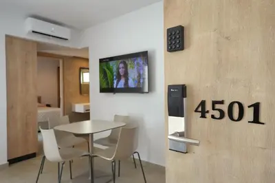 a room with a table and a tv on a wall at Panas Villas in Ayia Napa