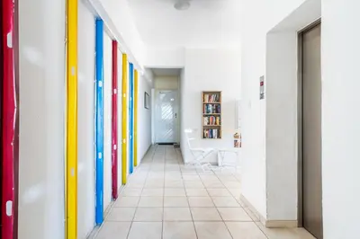 a hallway with brightly colored walls and a tile floor at Whispering Palms 1-BR Apt By Finikoudes Beach in Larnaka