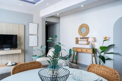 a living room with a table and chairs at Beach Daze 1-BR Apt By Finikoudes Beach in Larnaka