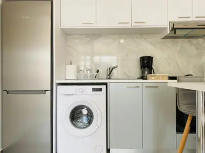 a kitchen with a washing machine and a sink at Pink Flamingo 1-BR apartment in Larnaca in Larnaka