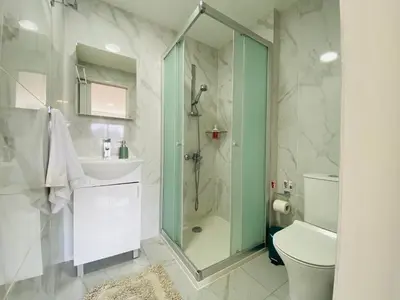 a bathroom with a shower and a sink and a toilet at Pink Flamingo 1-BR apartment in Larnaca in Larnaka