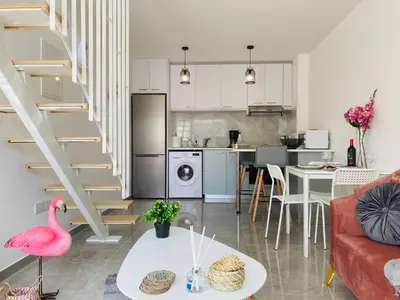 a living room and kitchen with a pink flamingo at Pink Flamingo 1-BR apartment in Larnaca in Larnaka