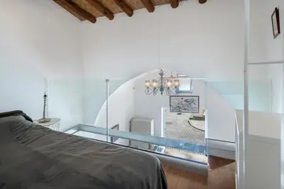 a glass room with a bed and a staircase at To Hani - Kamara Studio in Nicosia