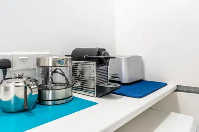 a kitchen counter with a coffee maker and appliances on it at To Hani - Kamara Studio in Nicosia