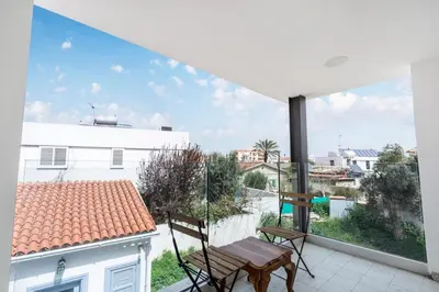 a balcony with a table and chairs on a roof at To Hani - Kamara Maisonette in Nicosia