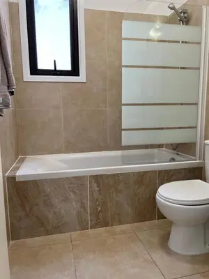 a bathroom with a toilet and a bath tub at AFRODITI APARTMENTs in Pervolia