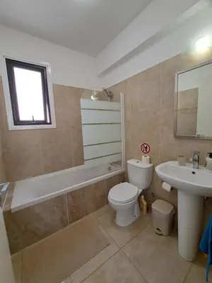 a bathroom with a toilet and a sink at AFRODITI APARTMENTs in Pervolia