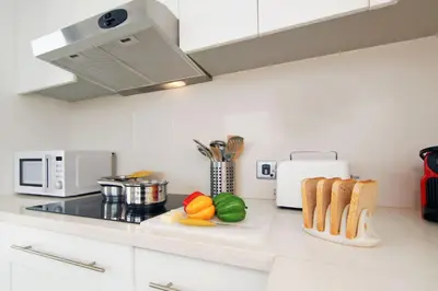 a kitchen counter with vegetables and bread on a cutting board at Villa Napa Seaside in Ayia Napa