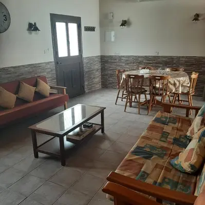 a living room with a couch and a table and chairs at HAVEN HOUSE in Larnaka