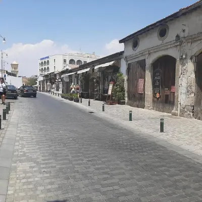 a cobblestone street in a city with buildings at HAVEN HOUSE in Larnaka