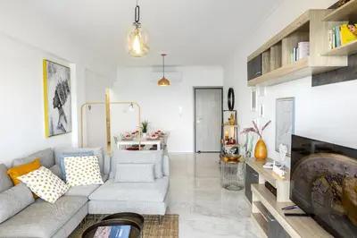 a living room with a couch and a fireplace at Lovely 3-bedroom apartment in Prokymea court in Limassol