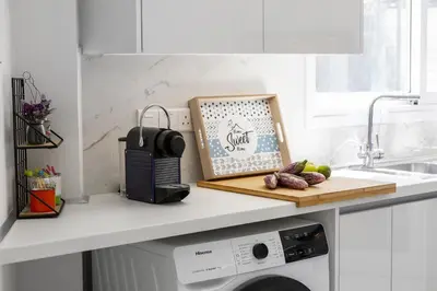 a kitchen counter with a dishwasher and a cutting board at Lovely 3-bedroom apartment in Prokymea court in Limassol