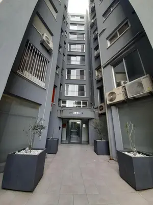 an empty hallway of an apartment building with potted plants at Lovely 3-bedroom apartment in Prokymea court in Limassol
