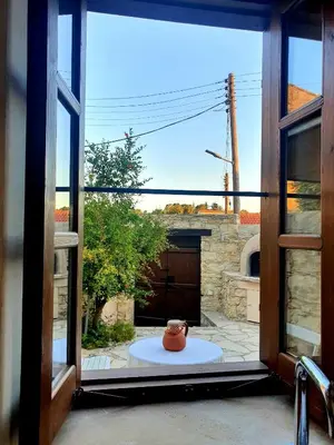 an open window with a view of a patio at myLofou in Lofou