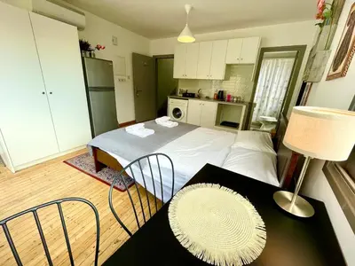a bedroom with a bed and a table with chairs at Irida - Studio Down Town Nicosia in Nicosia