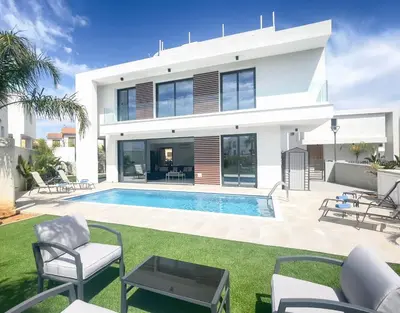 a house with a swimming pool in front of it at By The Beach - Royal Sapphire Villa in Protaras