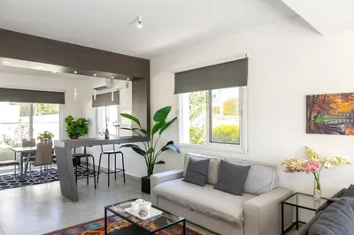 a living room with a couch and a table at Napa Bay View Villa in Ayia Napa