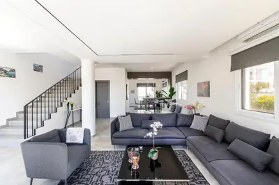 a living room with a couch and a table at Napa Bay View Villa in Ayia Napa