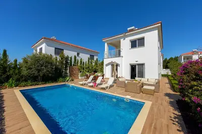 a villa with a swimming pool in front of a house at Napa Bay View Villa in Ayia Napa