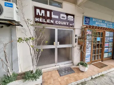 a mitzhews kitchen court building with a glass door at Sunbay City Rooms in Larnaka