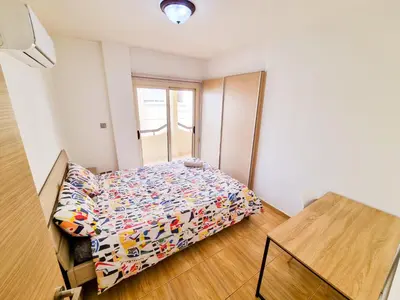 a small bedroom with a bed in a room at Sunbay City Rooms in Larnaka