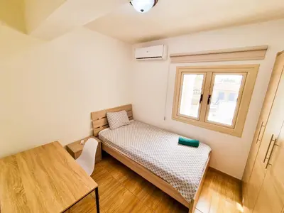 a small room with a bed and a window at Sunbay City Rooms in Larnaka