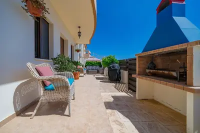 a patio with wicker chairs and a fireplace at Anna-Maria 3 bedroom villa in Paralimni