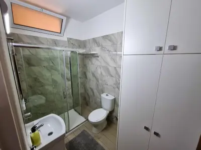 a bathroom with a toilet and a shower and a sink at Springfield Park Apartment in Larnaka