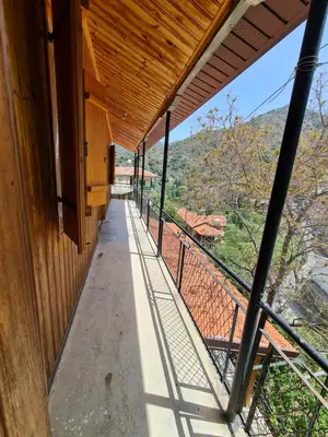 a balcony of a house with a view at Elpiniki's Old House in Kalopanayiotis